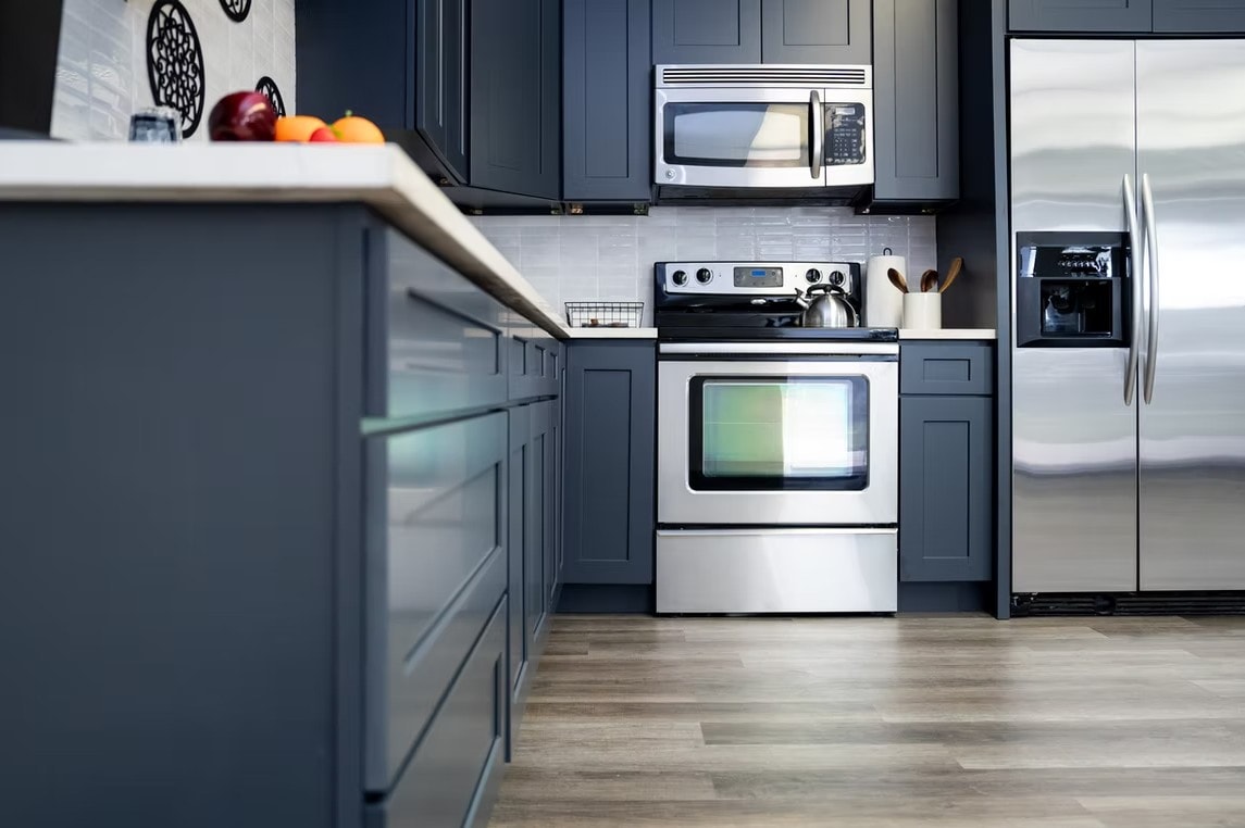 Cyber Grey kitchen close-up with stainless steel appliances and white countertop