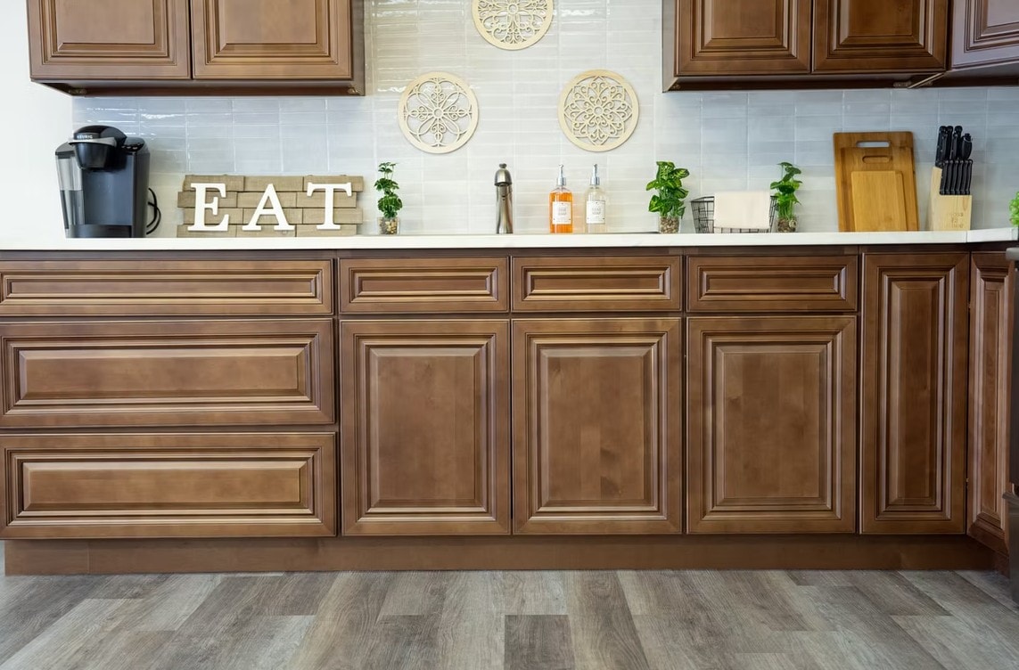 Dark Caramel lower cabinets with white countertop and tile backsplash