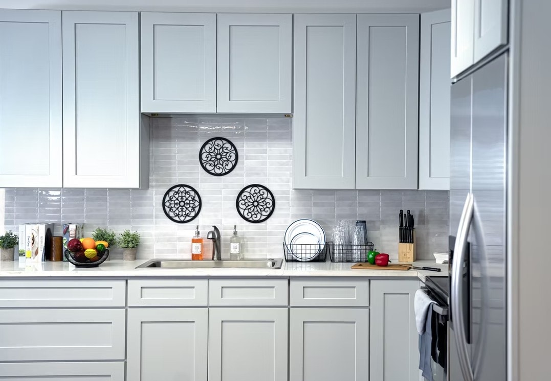 Front view of Dove Grey cabinets with tile backsplash and stainless steel appliances