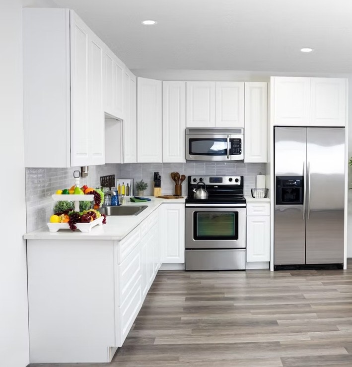 Glacier White kitchen with tall upper cabinets and stainless steel appliances