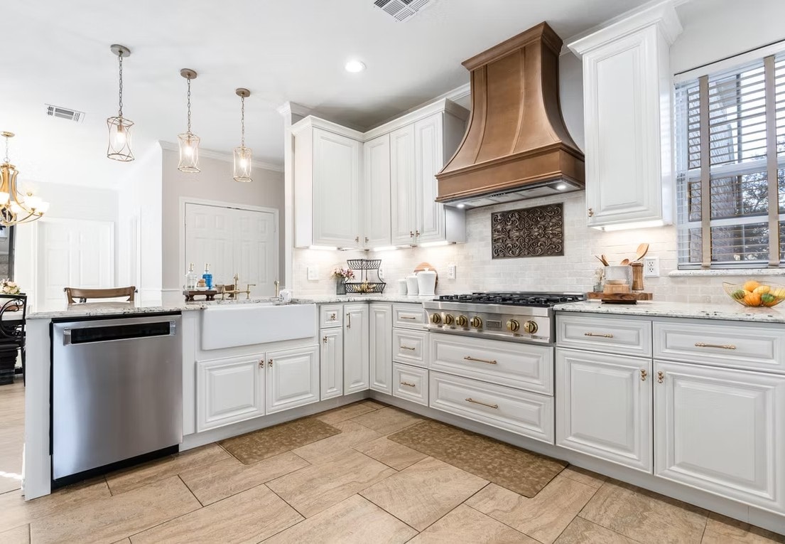 Pearl White kitchen with decorative copper hood, ZLINE range and marble backsplash