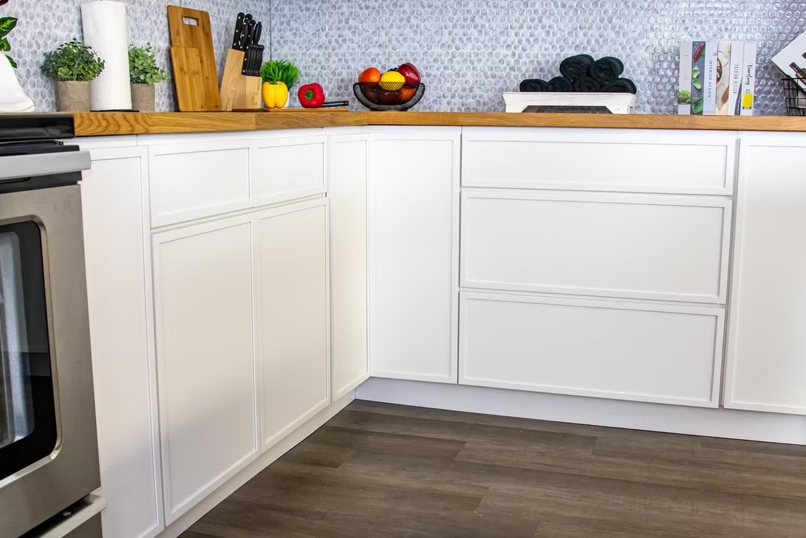 Detail of Slim Shaker Alabaster lower cabinets with wood countertop and mosaic backsplash